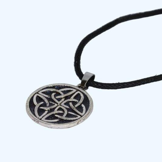 Silver Celtic knot pendant on a black cord against a white background